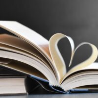 Open book with pages forming a heart, symbolizing love for reading and literature.